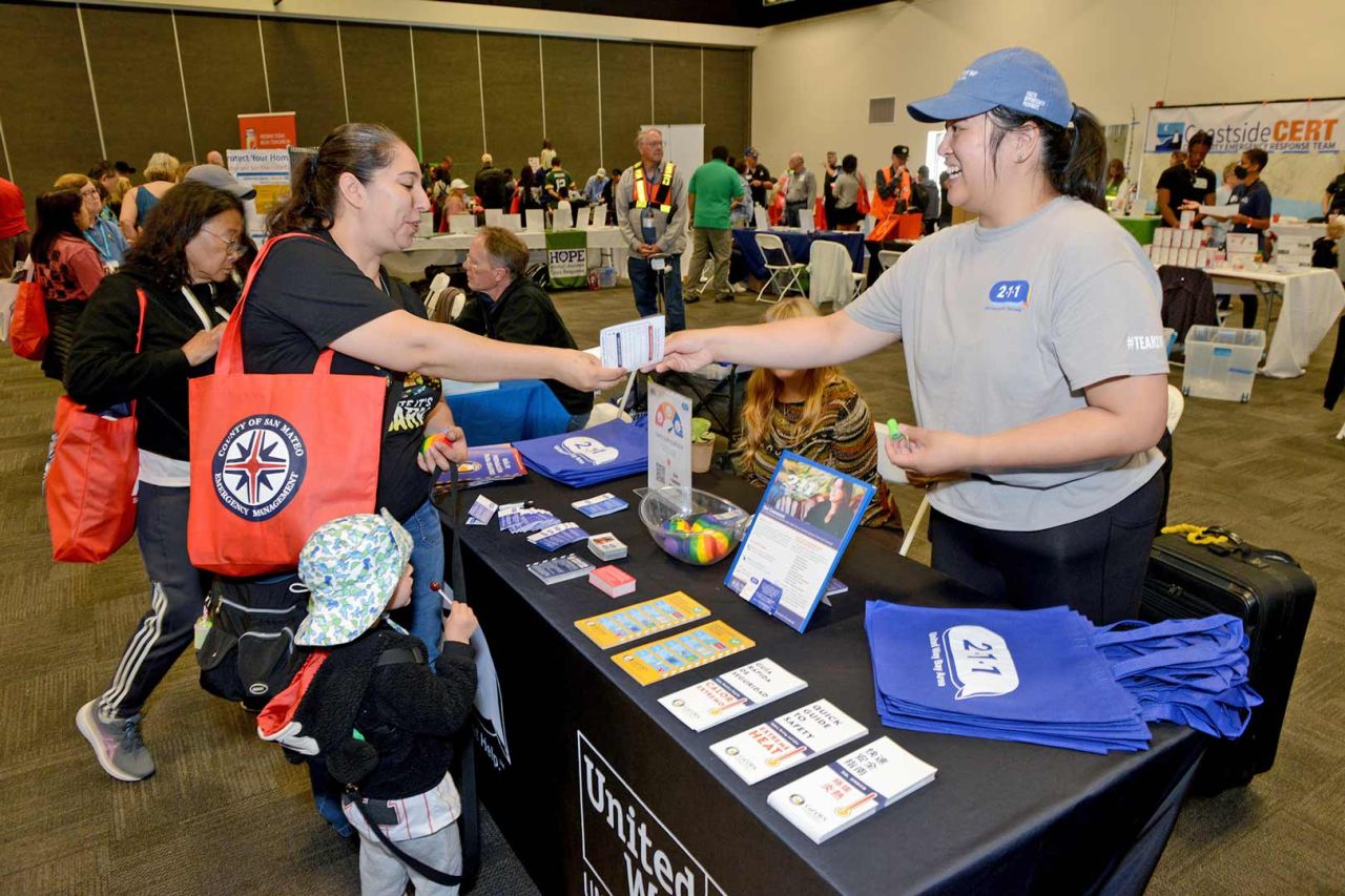 San Mateo County Emergency Management community event booth for United Way passing out 211 information