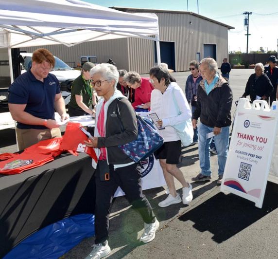staff handing out resources and information for Disaster Preparedness Day